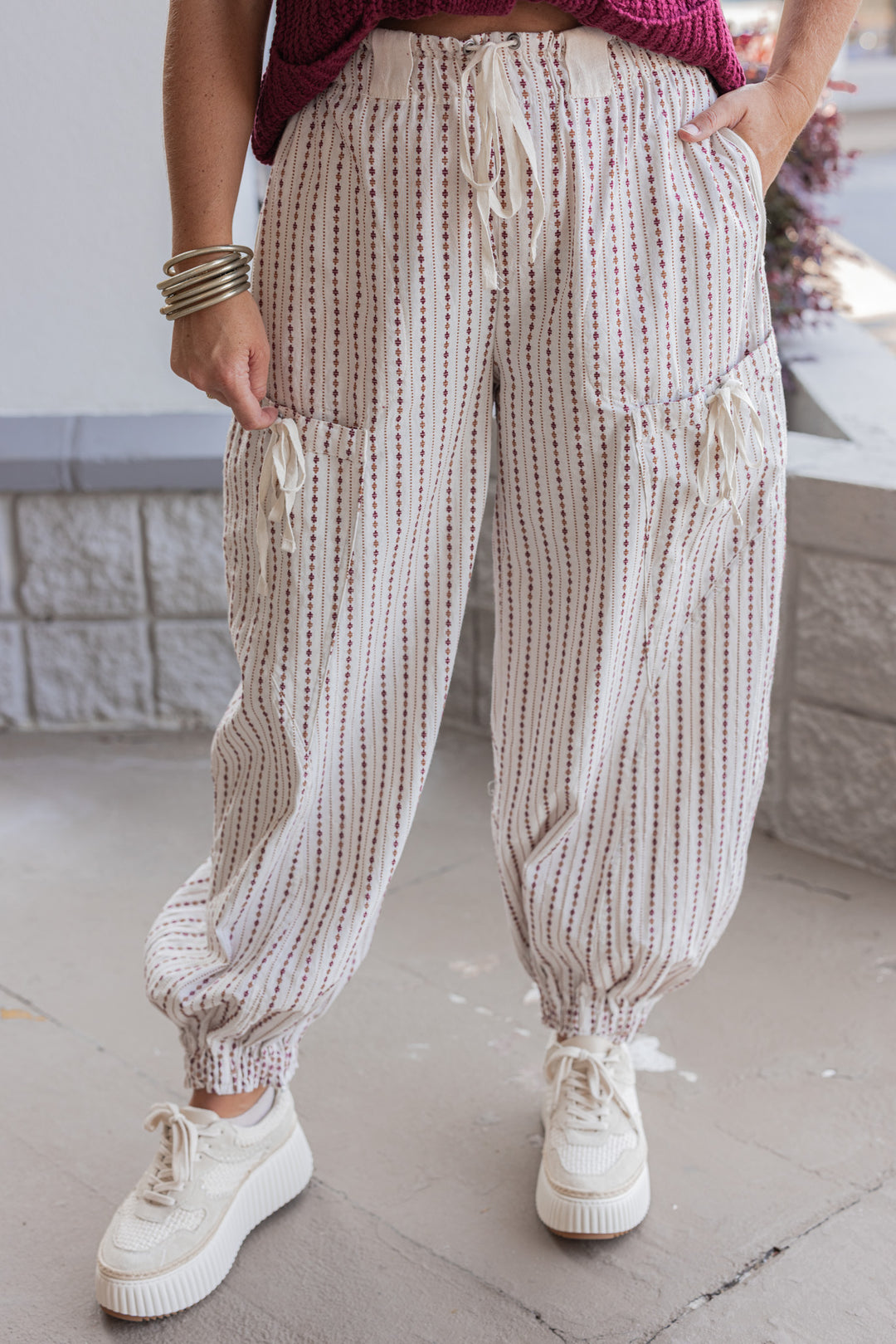 Women's oatmeal cargo jogger pants with redish brown and caramel print stripes by ee:some