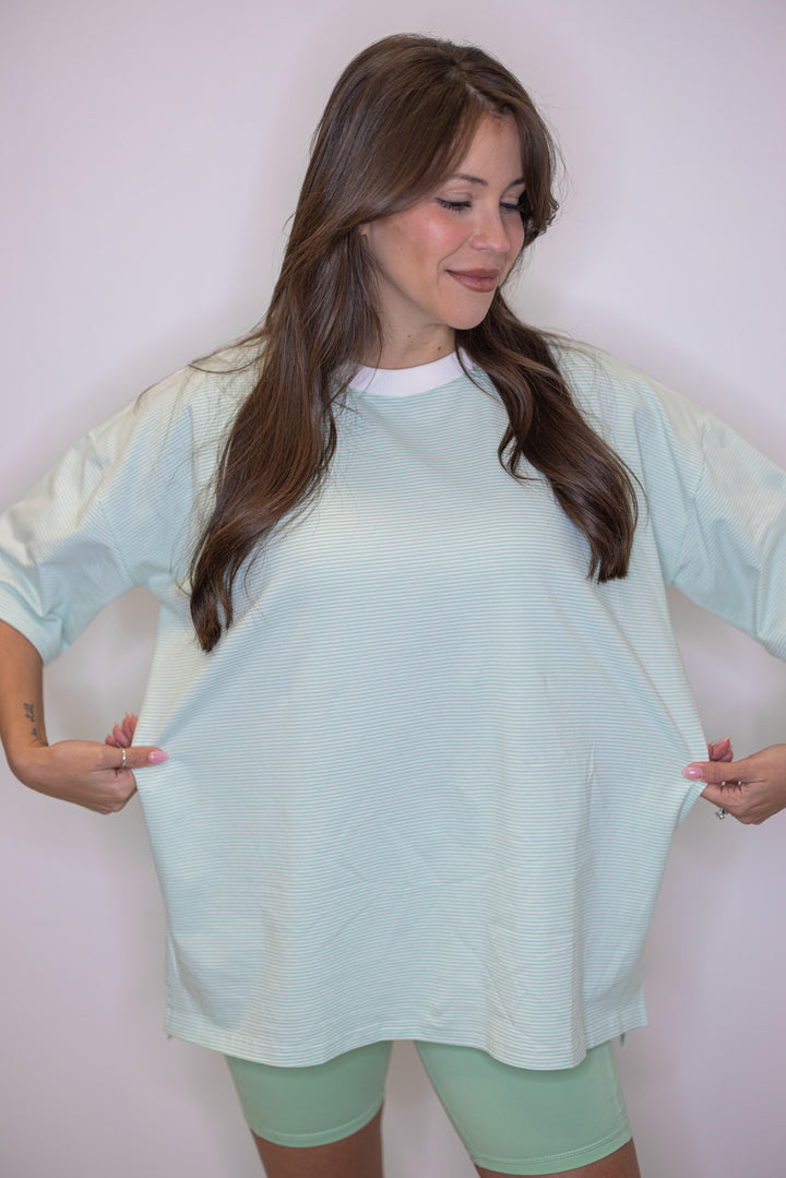 Women's mint green and white striped knit oversized top by Wishlist showing oversized fit