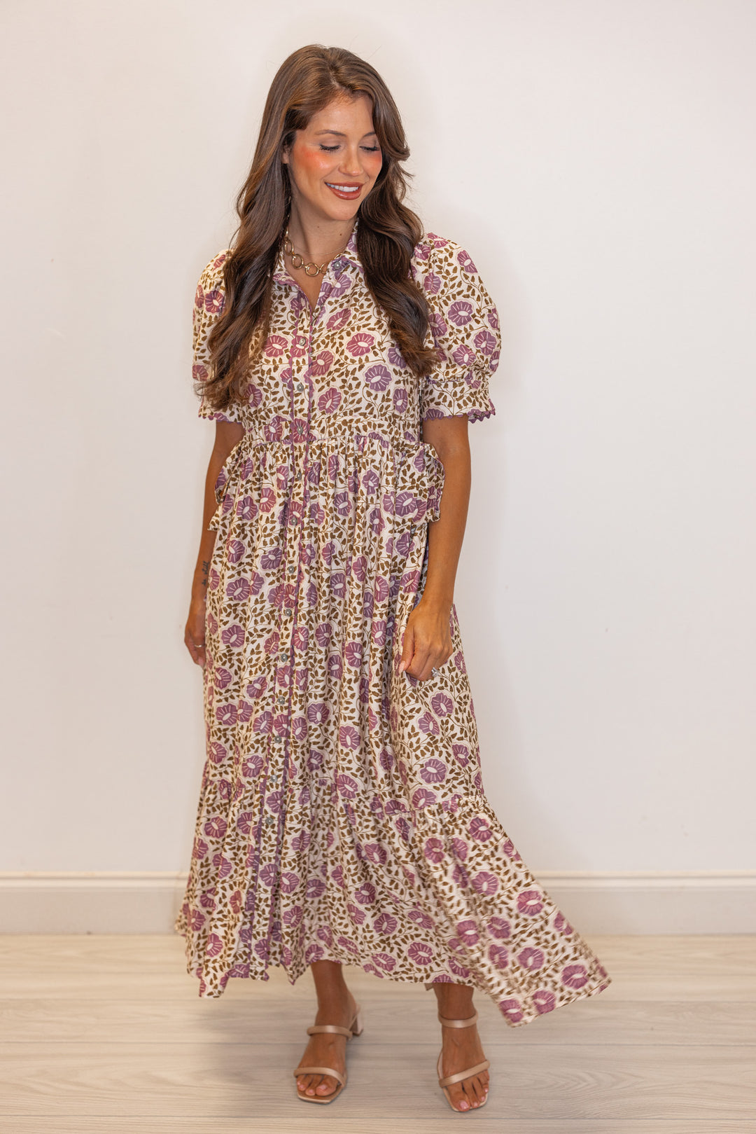 Women's cream button front midi dress with purple floral print by Entro showing tiered bottom hem