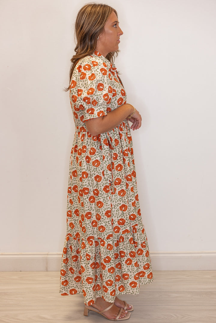 Women's cream button front midi dress with rust floral print by Entro showing full side view