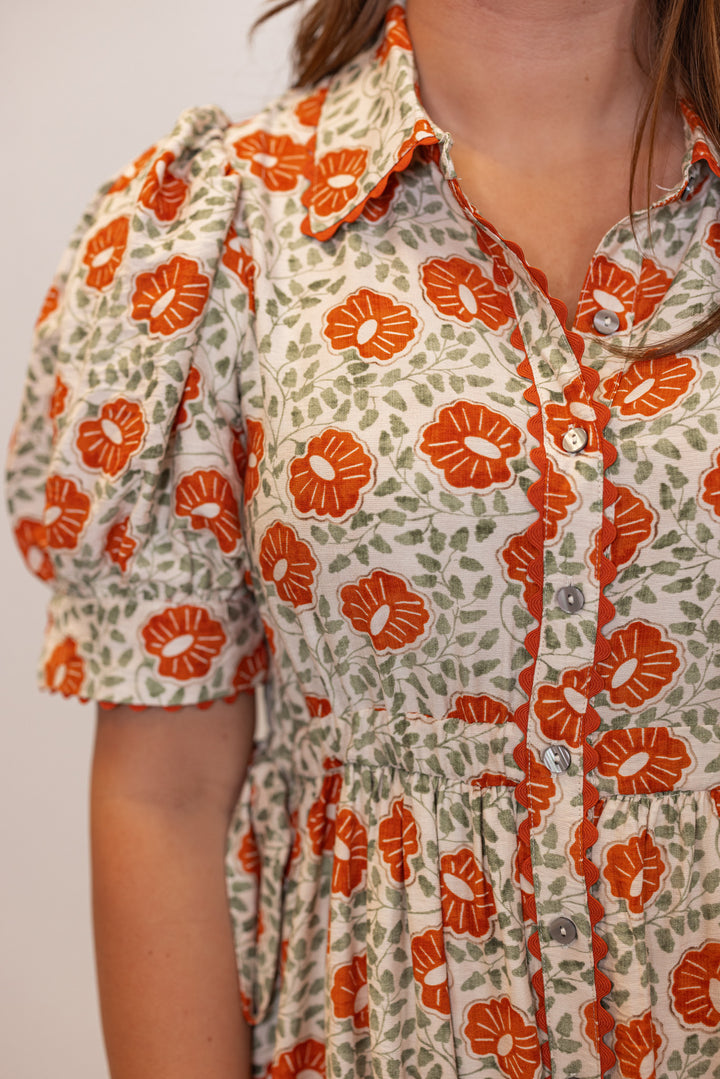 Women's cream button front midi dress with rust floral print by Entro showing button down front with collar