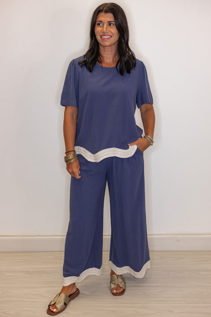 Women's linen top in medium blue color with oatmeal scalloped bottom hem by Umgee showing full front view