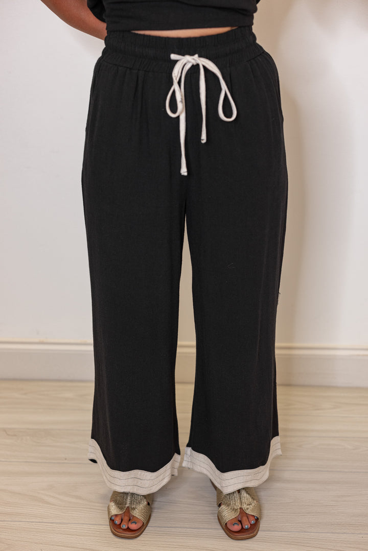 Umgee linen wide leg pants in black with oatmeal scalloped hem by Umgee showing up close front view