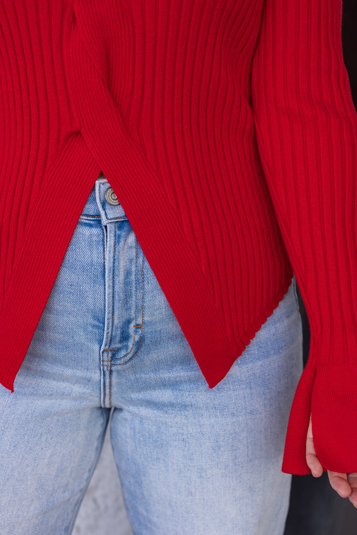 Women's red sweater knit top with a twisted front and peekaboo shoulders by So Me showing ribbed texture