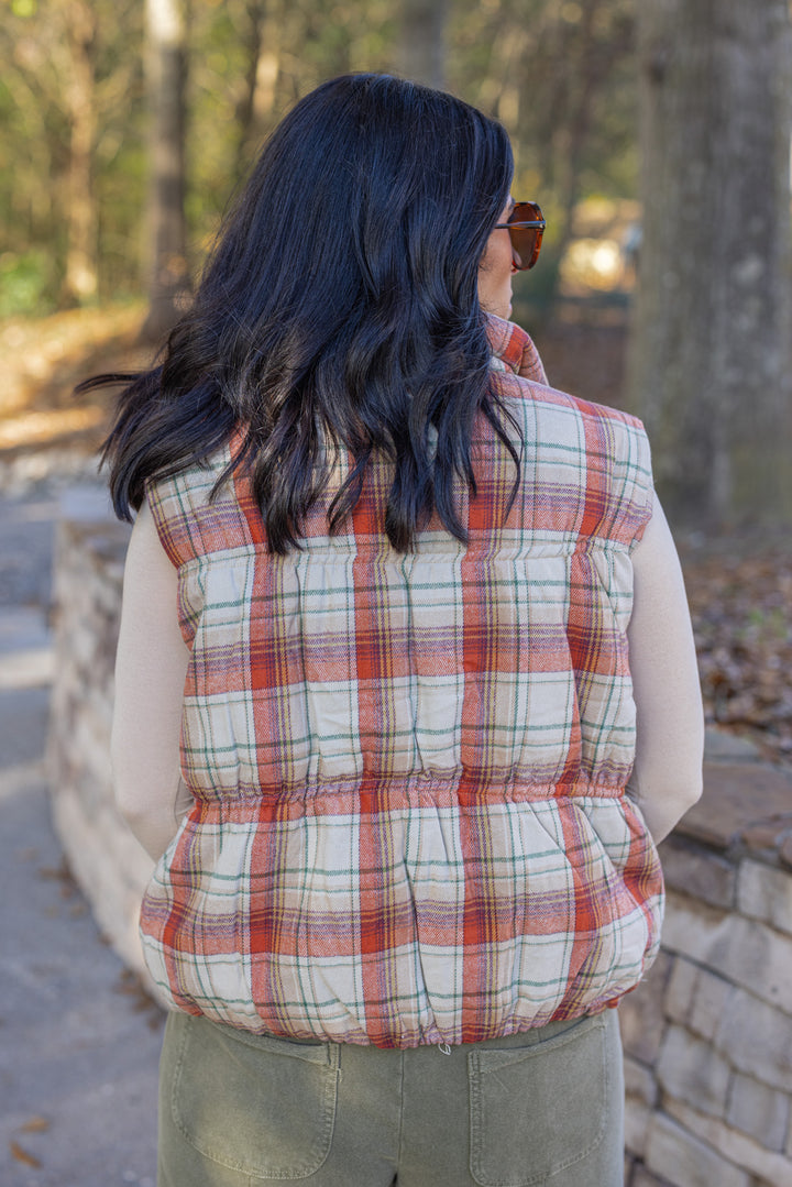 Women's quilted puffer vest in taupe, brown, persimmon orange and green plaid by Easel showing up close back view