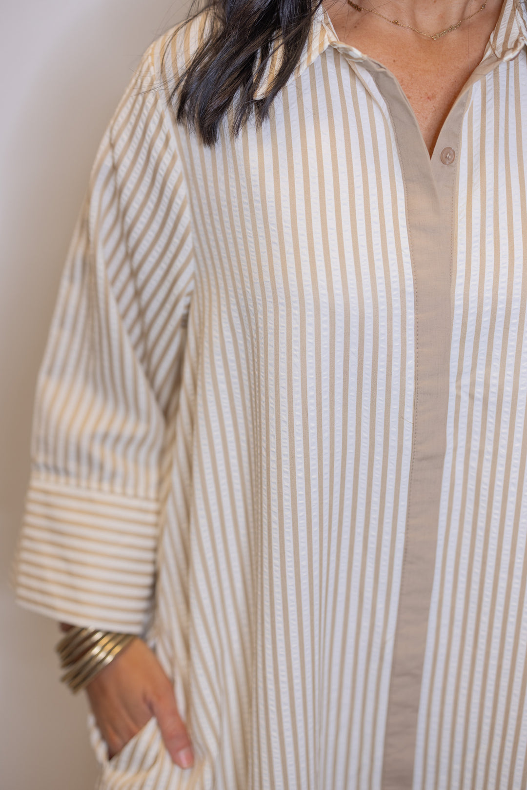 Women's striped light beige maxi dress by Entro showing side pockets and hidden buttons detail