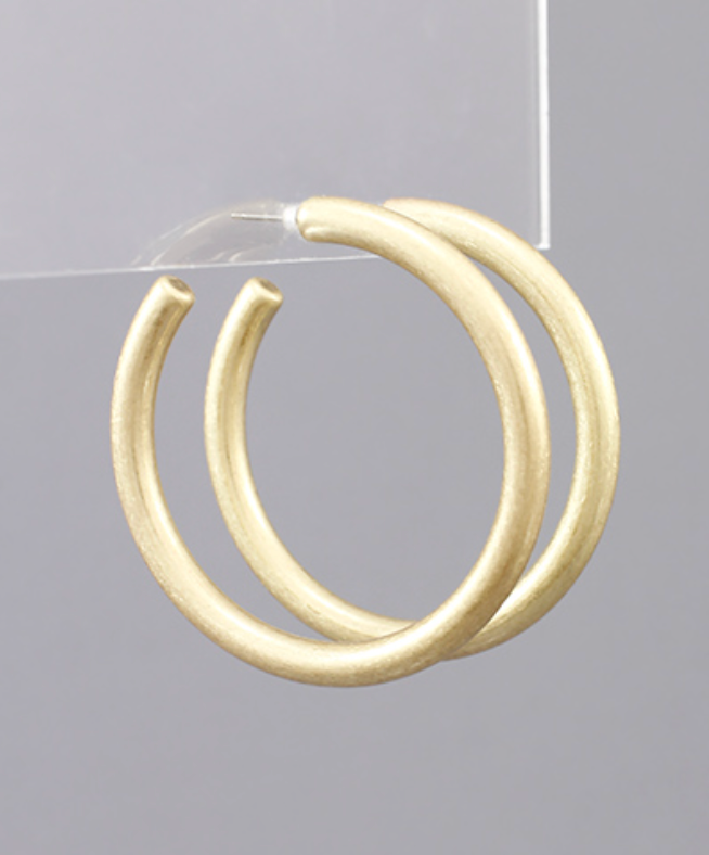 worn gold hoop earrings