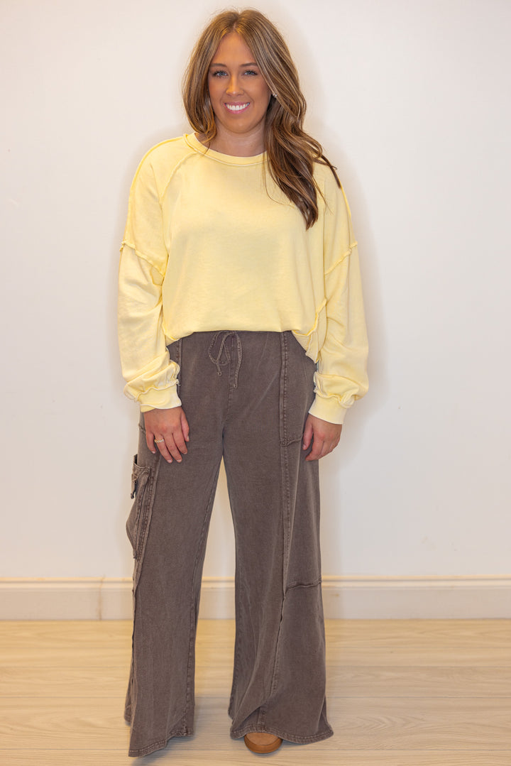 Mineral washed lemon yellow pullover top with front pockets by Easel shown styled with a front tuck