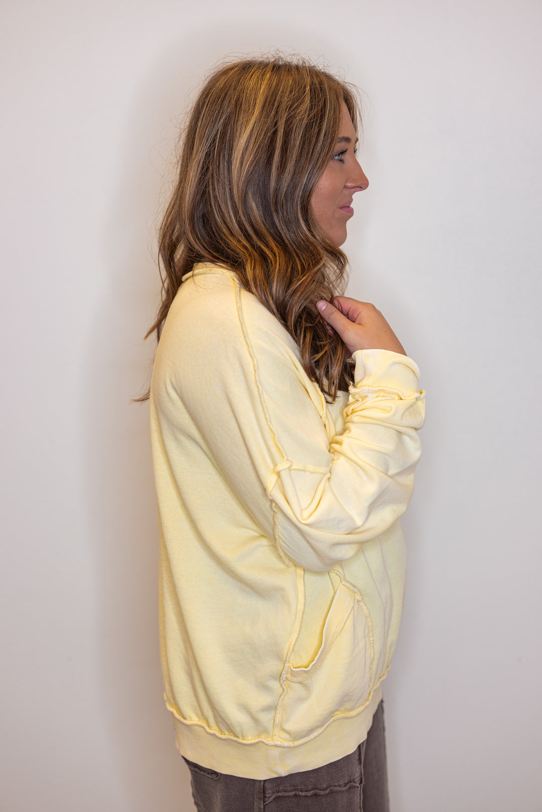 Mineral washed lemon yellow pullover top with front pockets by Easel showing up close side view
